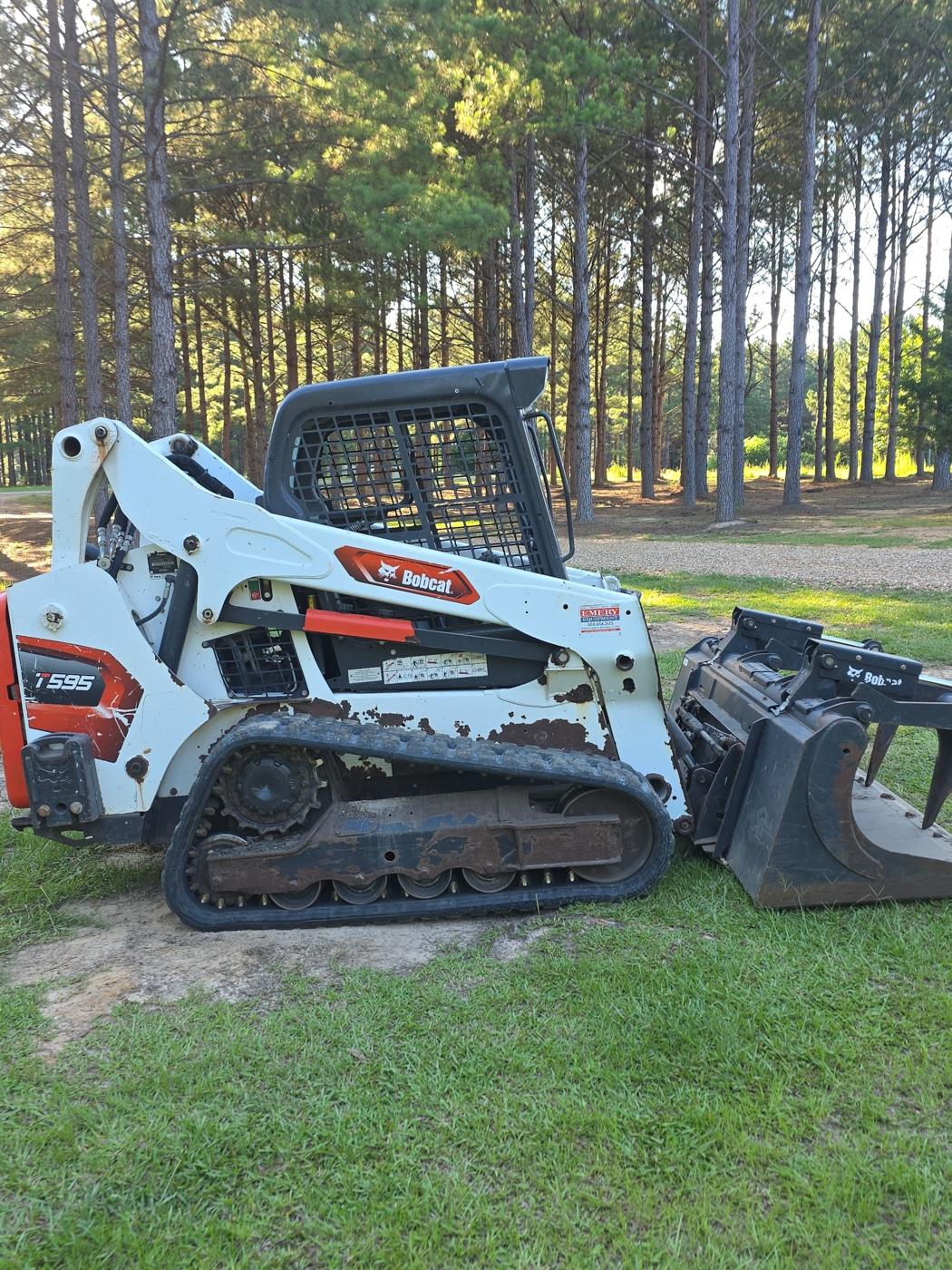 Skid steer used for land clearing and debris removal